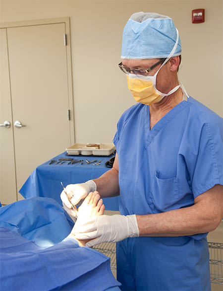 podiatrist performing surgery in the office - MVS Podiatry Associates